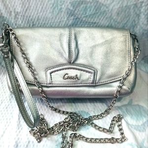 Coach silver crossbody wallet purse with silver chain in pink interior.